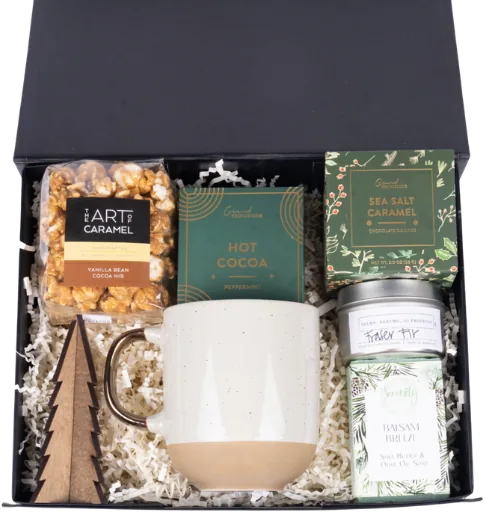 Black magnetic-lid box holding a speckled two-tone mug, mint hot cocoa, sea-salt caramel chocolate, caramel popcorn, a fir candle and a wooden tree